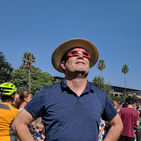 Mueller, a senior gift planning officer in the Office of Gift Planning, views the recent eclipse on campus. 