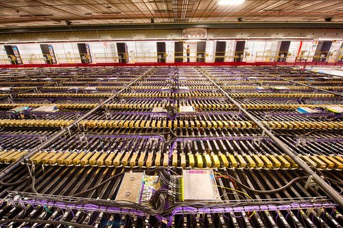 The NOvA far detector in Minnesota, made of 344,000 individual cells each 50 feet long and filled with a mixture of mineral oil and dissolved light-emitting chemicals. It&#x27;s endless rows of purple and gold blocks.