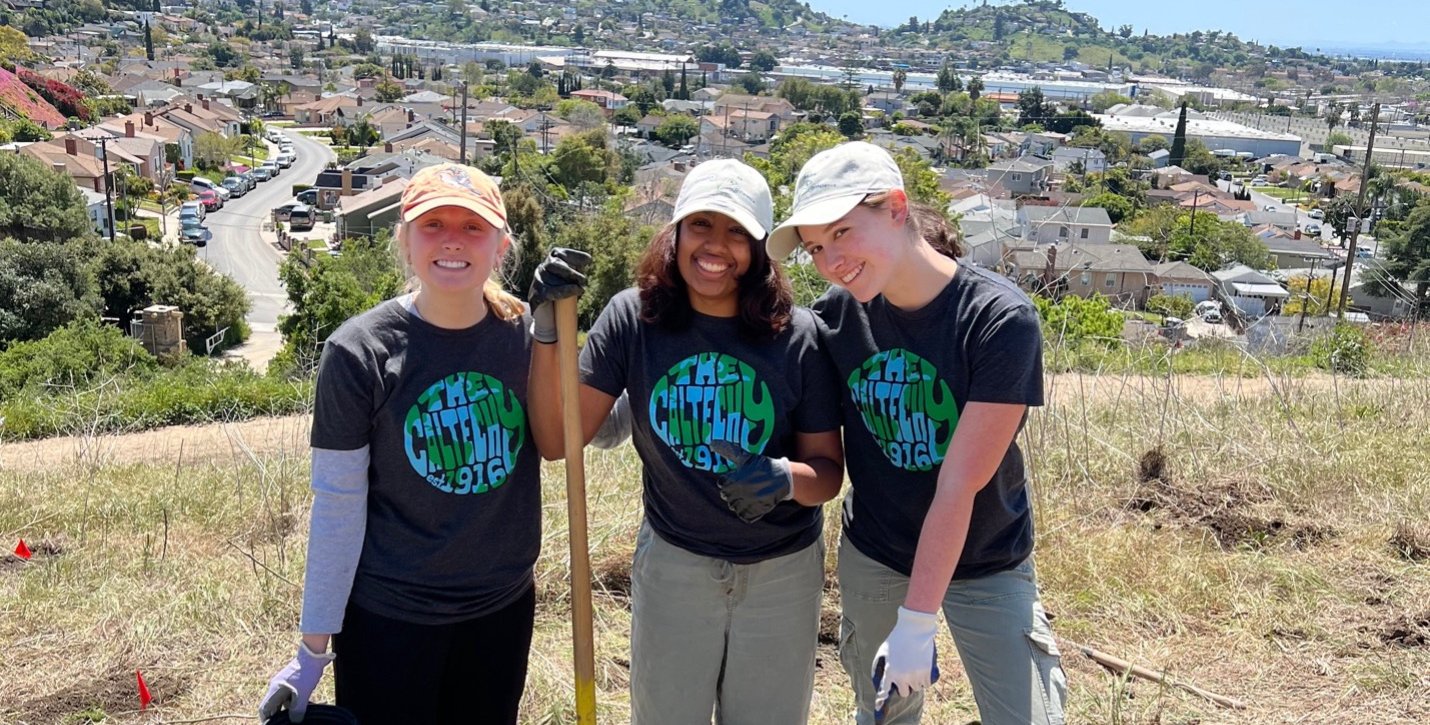 Three participants in the 2024 Caltech Y Make a Difference Day rest and smile for the camera after planting trees.