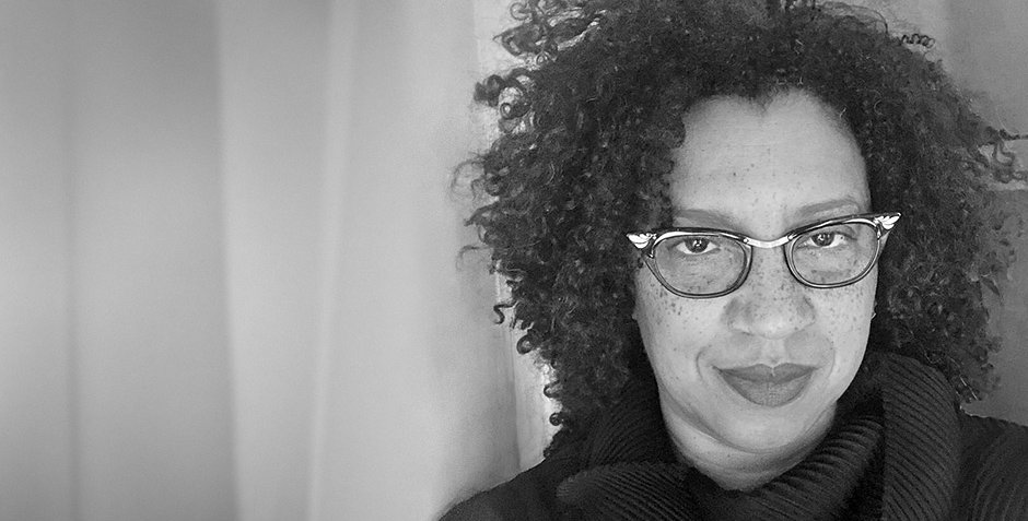 A black and white portrait of Robin Coste Lewis. The image is grainy, as though captured on old film.