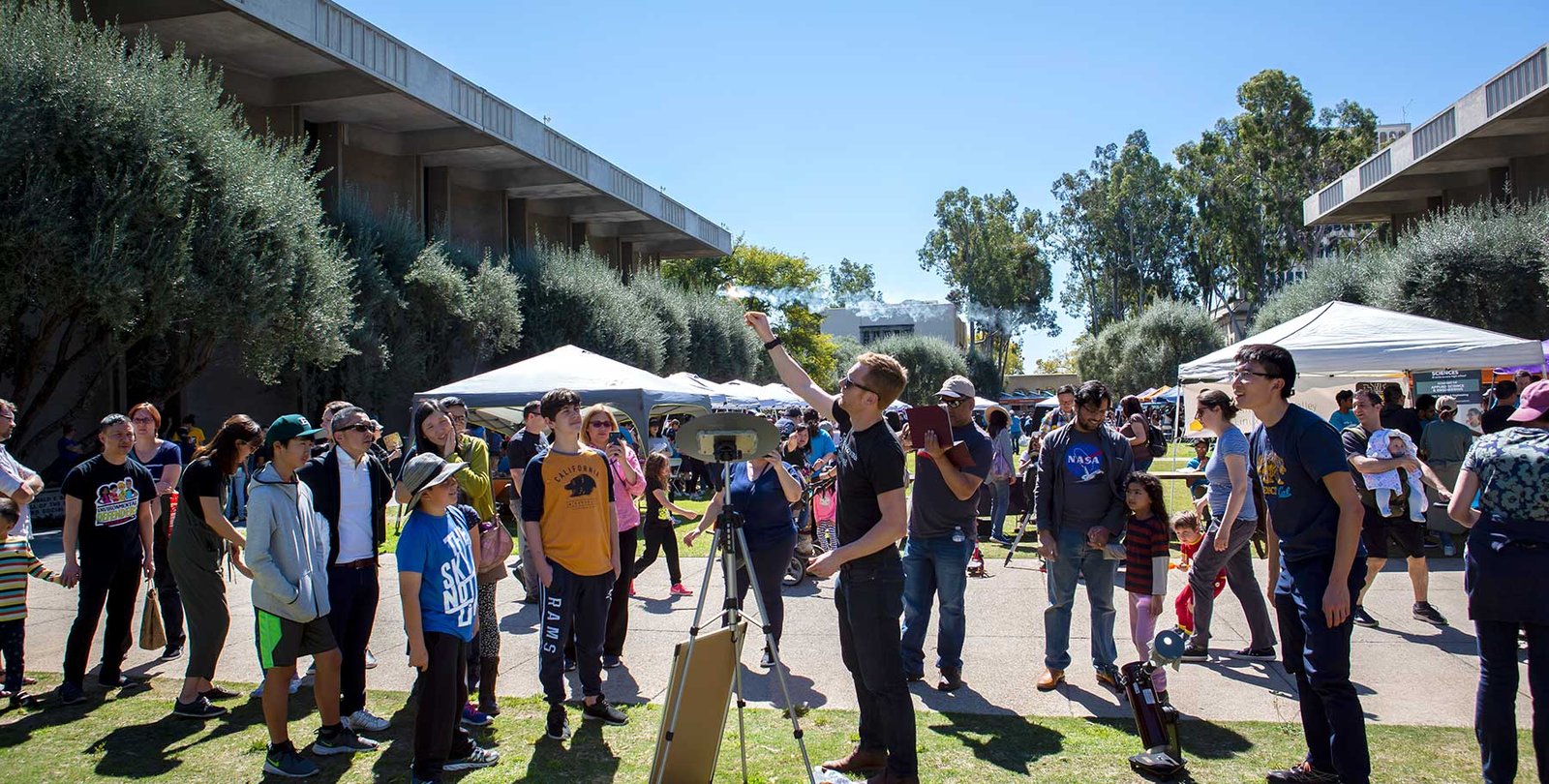 Postdoctoral scholar Cameron Hummels leads an astronomy demonstration while visitors to the second annual Science for March event watch.