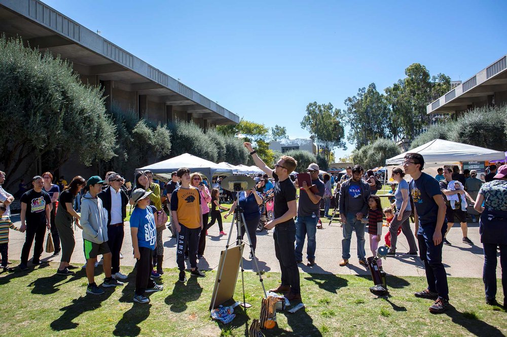 Postdoctoral scholar Cameron Hummels leads an astronomy demonstration while visitors to the second annual Science for March event watch.