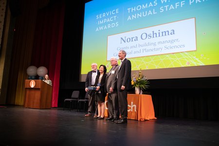 Nora Oshima (center left), grants and building manager for the Division of Geological and Planetary Sciences, accepts the Thomas W. Schmitt Annual Staff Prize.