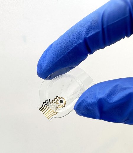 A small clear device with microfluid components visible.
