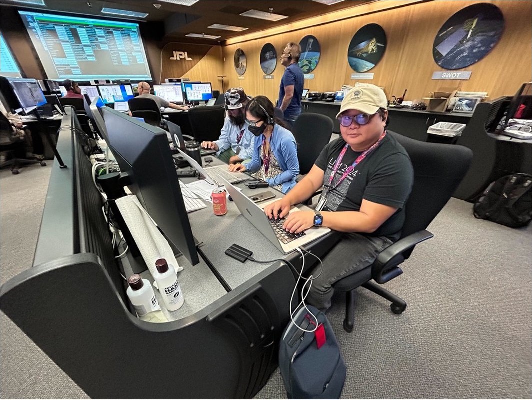 People huddled around computers during a SPHEREx readiness test.