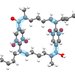 A chemical ring structure featuring gray, white, and red balls and sticks. Some of the bonds are highlighted in blue.