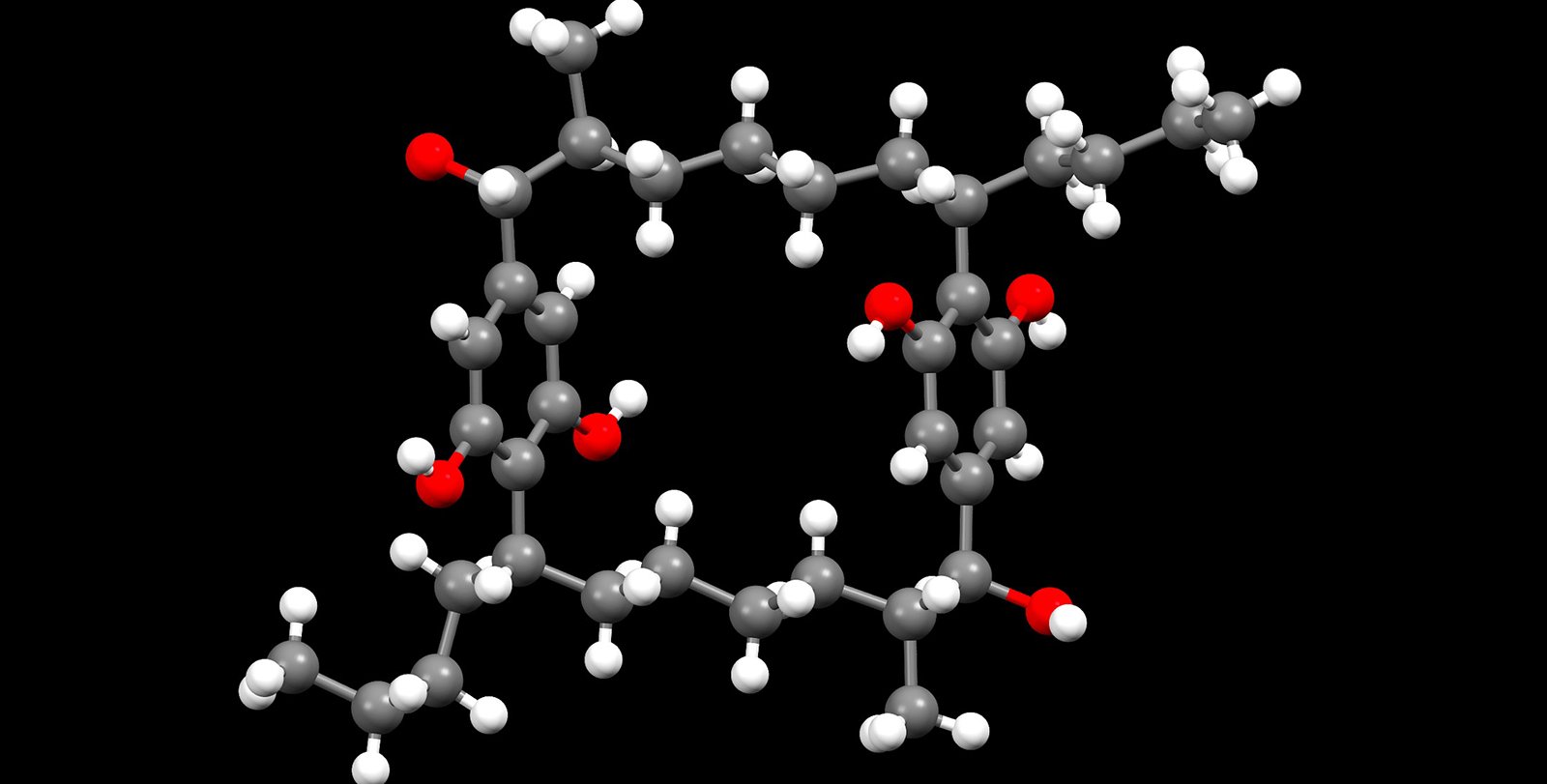 A chemical ring structure featuring gray, white, and red balls and sticks on a black background.
