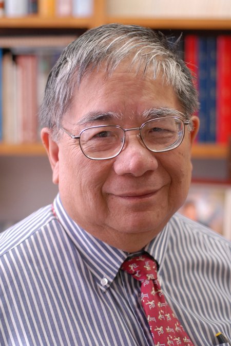 Sunney Chan with a bookcase behind him
