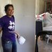 In Texas, junior Meera Krishnamoorthy installs drywall in partnership with All Hands All Hearts, an organization that rebuilds homes after natural disasters.