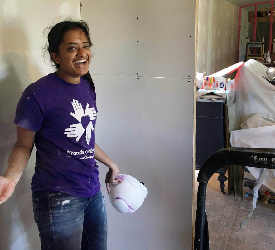 In Texas, junior Meera Krishnamoorthy installs drywall in partnership with All Hands All Hearts, an organization that rebuilds homes after natural disasters.