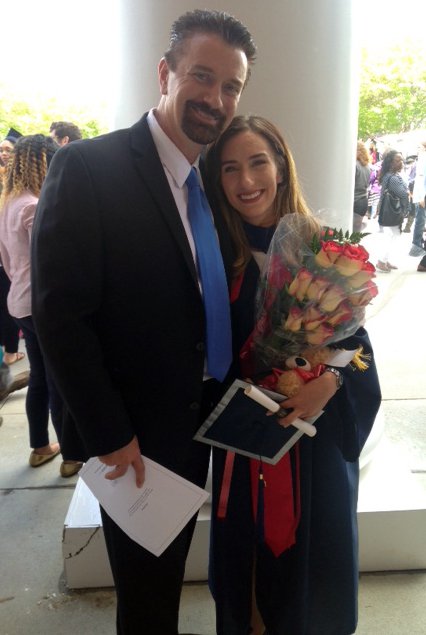 Winiecki poses with his daughter at her graduation in May. 