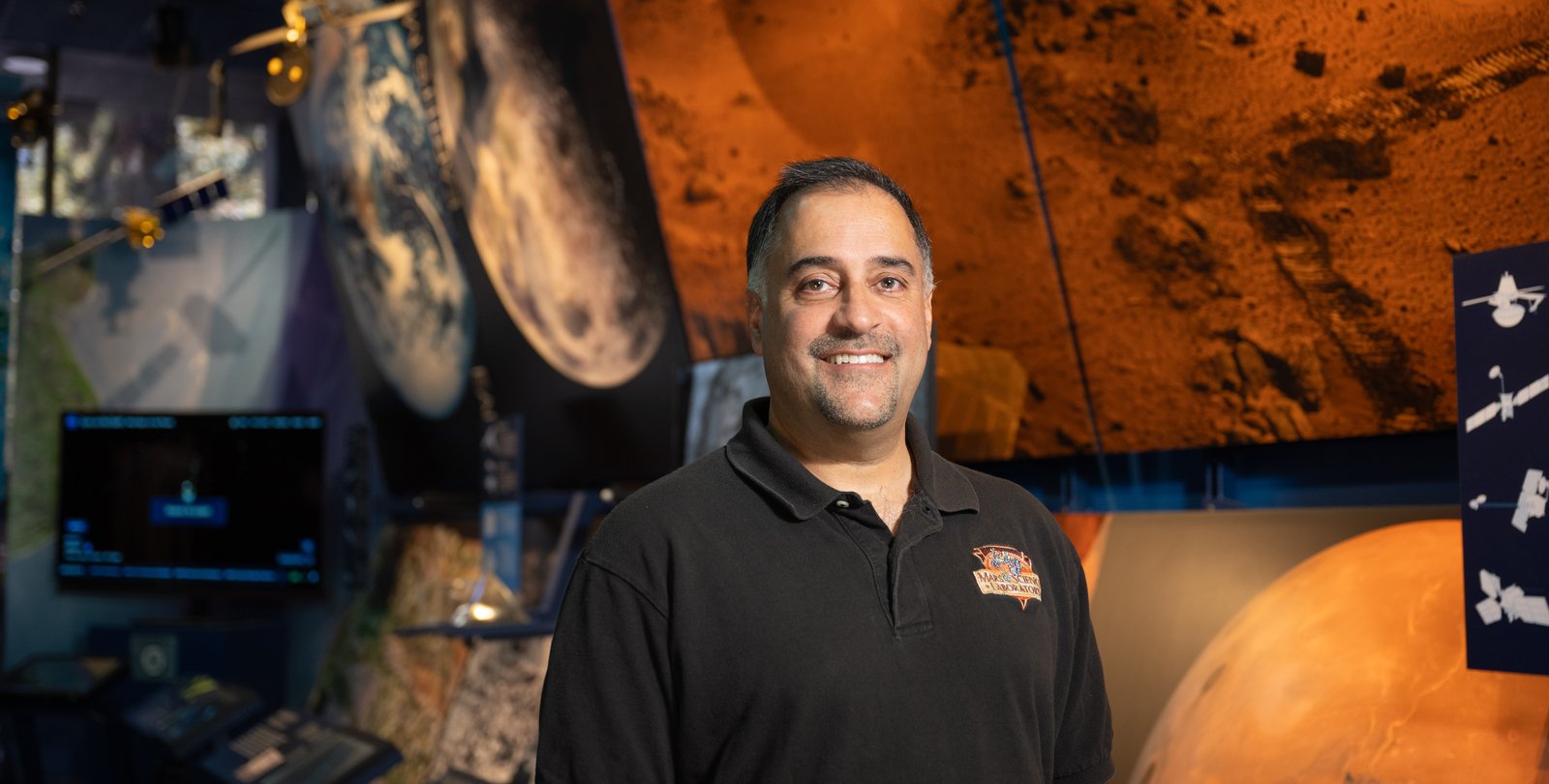Image of Ashwin Vasavada standing in front of Mars display