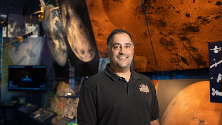Image of Ashwin Vasavada standing in front of Mars display