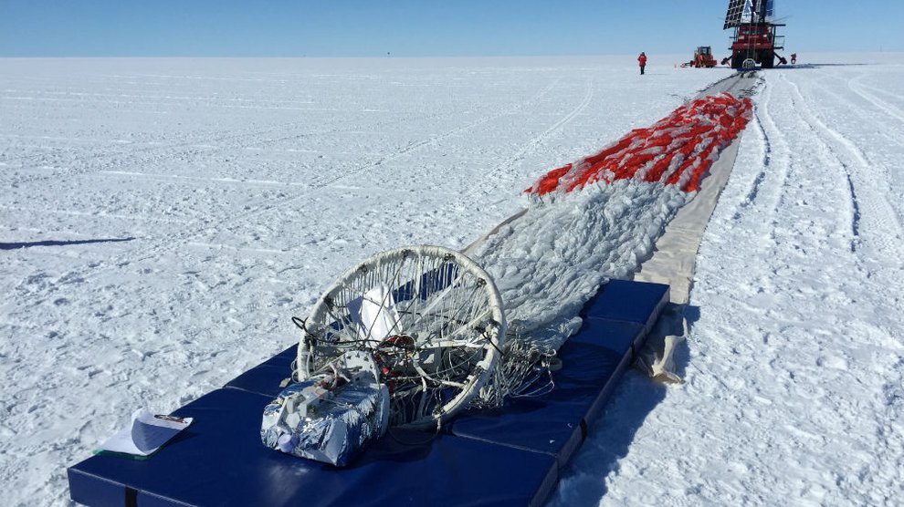 Parachute laid out on the snow in Antarctica preparing for launc